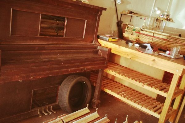 Piano mechanisms lined up in the workshop