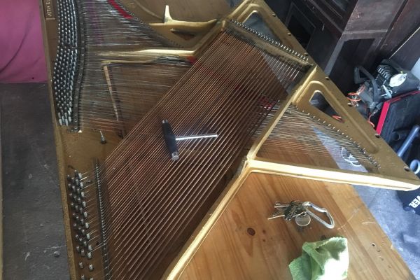 Piano frame being prepped for coffee table